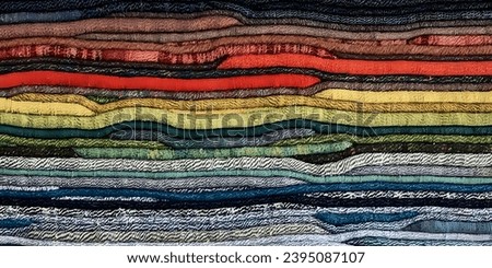 Immerse your projects in the bold hues of deep red, black, yellow, and subtle gray, crafted from a captivating array of traditional fabric stacks. This dynamic background exudes cultural richness