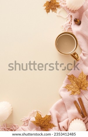 Immerse yourself in the captivating autumn vibe. Top view vertical photo of pink blanket, candles, cup of coffee, cinnamon sticks, acorn, fallen leaves on pastel beige background with marketing space