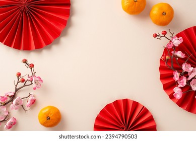 Immerse yourself in joy of Chinese New Year with this enchanting composition. Overhead shot of fans, and symbolic elements, like sakura and fruits on neutral background, perfect for your festive text - Powered by Shutterstock