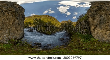 Immersive 360-degree equirectangular panorama captures a turbulent mountain river flowing through a rocky gorge in Kyrgyzstan. Lush greenery and steep cliffs frame the swift current, illuminated by bright daylight.