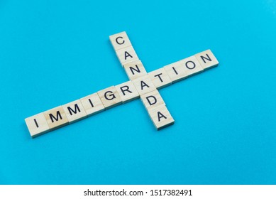 Immigration Minimalistic Concept. Isolated Wooden Letter Blocks With Word Cloud Immigration To Canada