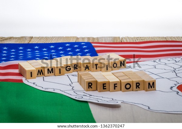 Immigration Reform concept on US-Mexico border with\
United States and Mexico\
flags
