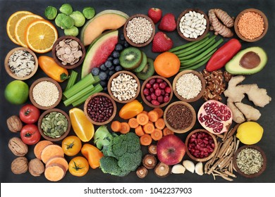 Immune Boosting Health Food Concept With Fruit, Vegetables, Seeds, Pulses, Grains, Cereals, Herbs  Spices With Foods High In Vitamins, Minerals, Anthocyanins, Antioxidants  Fibre On Slate. Flat Lay.