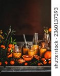 Immune boosting vitamin health defending drink. Turmeric, ginger and citrus juice shots in bottles and fresh plant ingredients over kitchen counter, copy space. Pure vegan Immunity booster