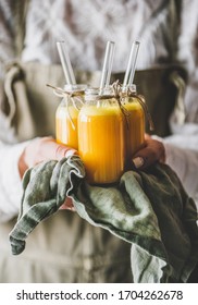 Immune Boosting Vitamin Health Defending Drink. Woman Bottles With Fresh Turmeric, Ginger And Citrus Juice Shots In Hands, Selective Focus. Pure Vegan Immunity System Booster