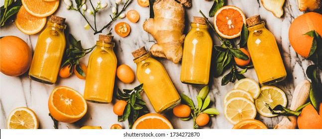 Immune Boosting Vitamin Health Defending Drink. Flat-lay Of Fresh Turmeric, Ginger, Citrus Juice Shot In Bottles Over Marble Background, Top View, Wide Composition. Vegan Immunity System Booster