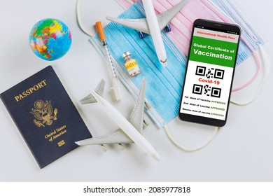 Immune Passport Certificate For Travel COVID-19 Vaccination Record Certification On Phone In The US Passport And Medical Mask.