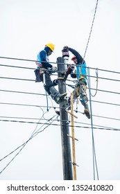 Imogiri, Bantul, Yogyakarta, Indonesia-2018: Two Man Climbing The Power Grid To Maintain The Electricity Failure