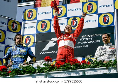 Imola, Italy. 21/23 April 2006. F1 World Championship. Grand Prix of San Marino. Michael Schumacher, Germany, Ferrari, winner, celebrating on the podium with Fernando Alonso and Juan-Pablo Montoya.