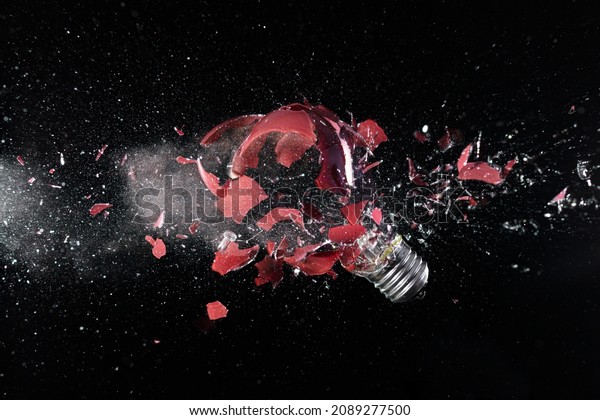impact explosion
of a red light bulb on
black