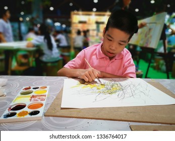 Impact Muang Thong, Bangkok, Thailand - MAR 08, 2019: Disabled child on the wheelchair is excited to draw with other people in the art exhibition.
