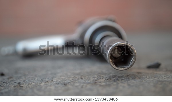 Impact Wrench on\
Worn Cement Focus on\
Socket