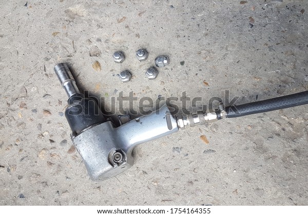 Impact\
wrench for twisting and unscrewing threaded fasteners during\
installation and repair work of automobile\
wheels.