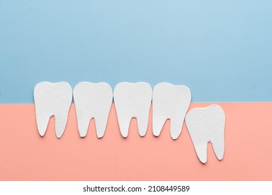 Impacted wisdom teeth with healthy tooth cartoon made from paper. Dental problems associated with wisdom teeth include tooth decay, jaw pain, oral infection or gum disease. Creative idea. - Shutterstock ID 2108449589