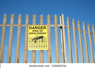 Impalement Danger And Risk Sign On Fence For Security And Protection