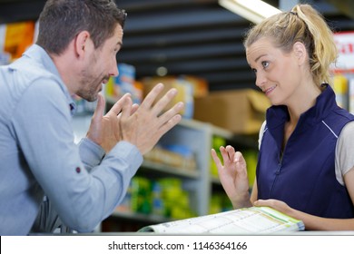 Impatient Customer Talking To Sales Clerk In Hardware Store