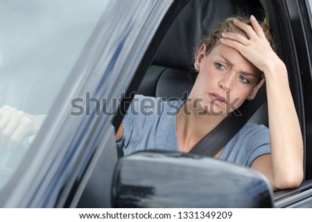 impatient female car driver stuck in traffic