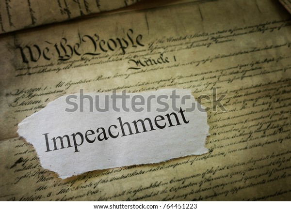 Impeachment news headline on a copy\
of the United States Constitution                              \
