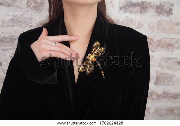 Impeccable perfect jewelry. Woman wear glamorous\
pin brooch. Fashion trend. Jewelry shop. Girl model long hair\
demonstrating golden jewelry brooch. Expensive accessory.\
Fashionable jewelry.