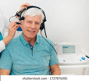 Impedance Audiometry, Diagnosis Of Hearing Impairment. An Elderly Man Getting An Auditory Test In A Hearing Clinic, Close Up.