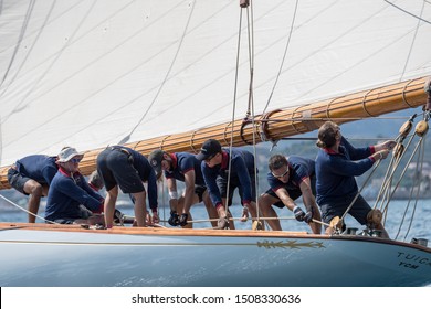 Imperia, Italy - September 7, 2019: Crew members aboard on sailboat Tuiga, flagship of the Monaco Yacht Club, during racing in Gulf of Imperia