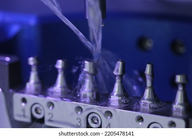 Implant custom abutments being made by wet milling - Shutterstock ID 2205478141