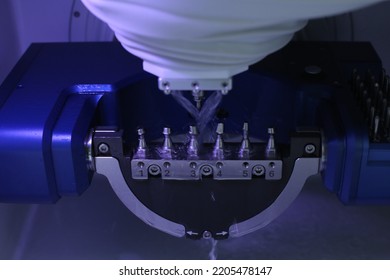 Implant custom abutments being made by wet milling - Shutterstock ID 2205478147