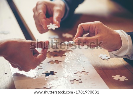 Implement improve puzzel solve connections together with synergy strategy team building organizing connection by trust communication. Hands of stakeholders business trust team holding jigsaw puzzle