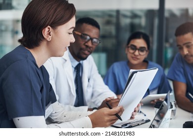 Implement Those Changes And We Can See. Shot Of A Group Of Nurses And Doctors Having A Meeting Together.