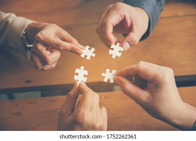 Implementation improving connections strategy team solution organization.Piece of jigsaw assembly by Implement puzzle. Hands of team connecting group of business people solutions success strategy