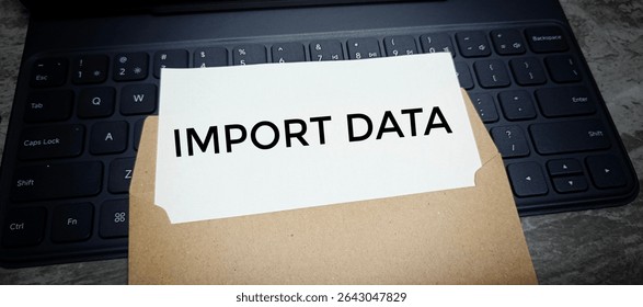 Import Data Document in Brown Envelope on Computer Keyboard Representing Confidential Global Trade Information or Customs Submission Concept. 