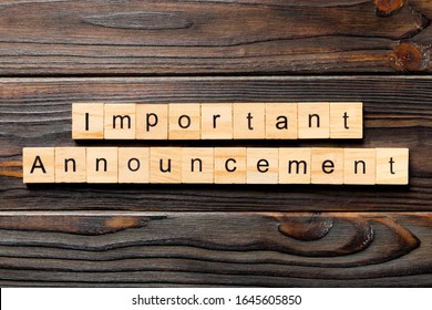 Important announcement word written on wood block. Important announcement text on wooden table for your desing, Top view concept.