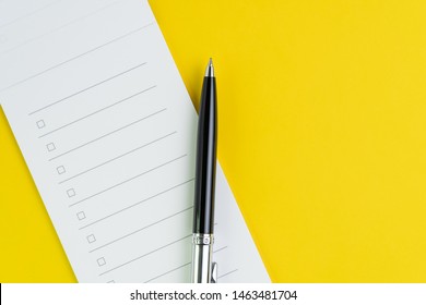 Important Business Checklist, Planning For Shopping Reminder Or Project Priority Task List, Black Pen On Small Notepad With Checkbox On Solid Yellow Background With Copy Space.