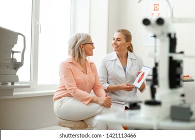 Important conversation. Beaming long-haired woman having appointment with older patient and discussing her issues