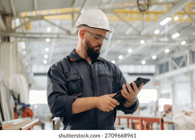 Important data, reading. Warehouse worker in an industrial environment of a factory or storage area.