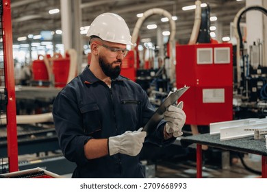Important data, reading. Warehouse worker in an industrial environment of a factory or storage area.