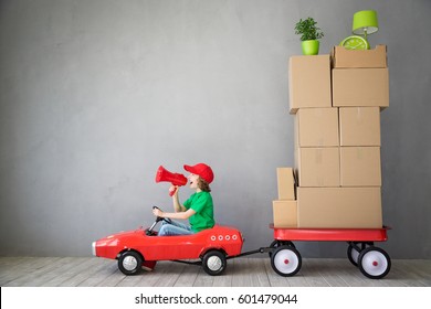 Important Message - We Are Moving! Happy Child Playing Into New Home. Kid Having Fun Indoor. Moving House Day And Express Delivery Concept