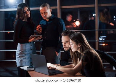 Important Not To Distract. Team Of Young Business People Works On Their Project At Night Time In The Office.