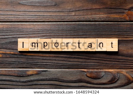 important word written on wood block. important text on wooden table for your desing, concept.