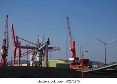 Imported Coal Alongside A Wind Turbine At The Port Of Bristol Avonmouth Docks UK