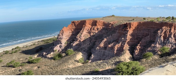 The imposing cliff at Punta do Mel in Brazil. Colorful ocean front mountain