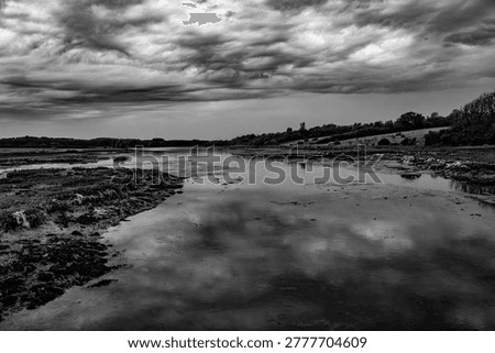 imposing dark storm clouds over Newtown Creek on the Isle of Wight.  Monochrome image