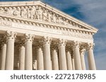 Imposing facade of the United States Suprement Court in Washington, DC with blue sky and copy space.