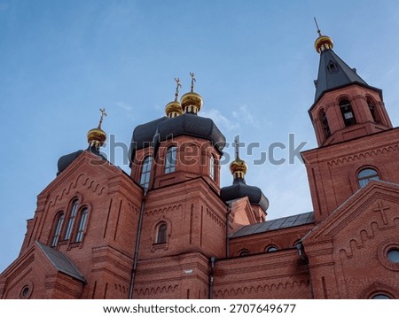 Imposing holy structure featuring classic black domes and elegant golden crosses