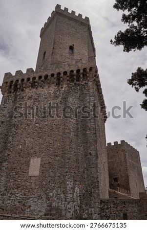 Imposing low-angle view of medieval stone towers in Erice - Sicily, Italy