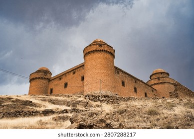 Imposing medieval castle against a dramatic cloudy sky