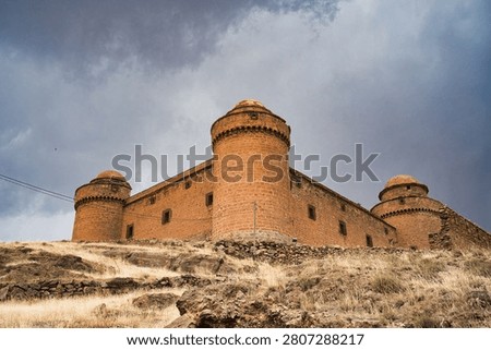 Imposing medieval castle against a dramatic cloudy sky
