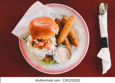 Impossible Burger With Cutlery And Side.