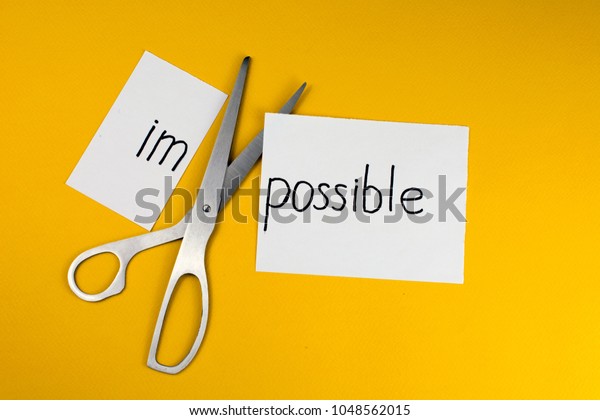 Impossible Is Possible\
Concept. card with the text impossible, cutting the word im so it\
written possible. 