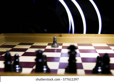 Impossible, Single pawn chess piece against against an army, with light painted background